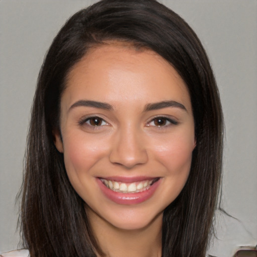 Joyful white young-adult female with long  brown hair and brown eyes