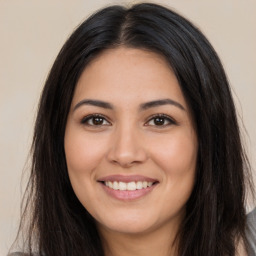 Joyful latino young-adult female with long  brown hair and brown eyes