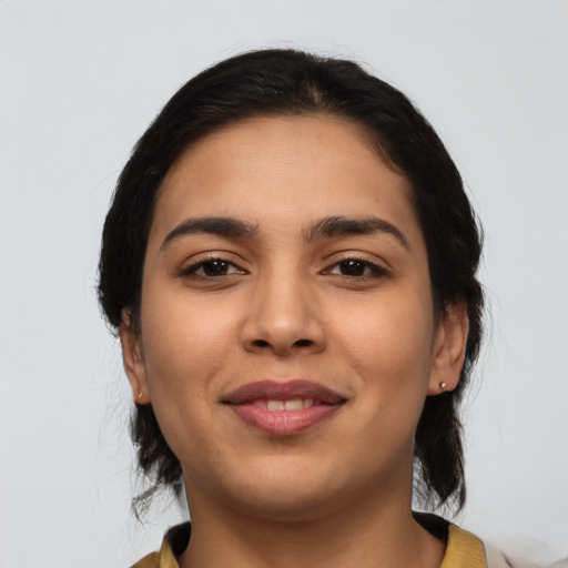 Joyful latino young-adult female with medium  black hair and brown eyes