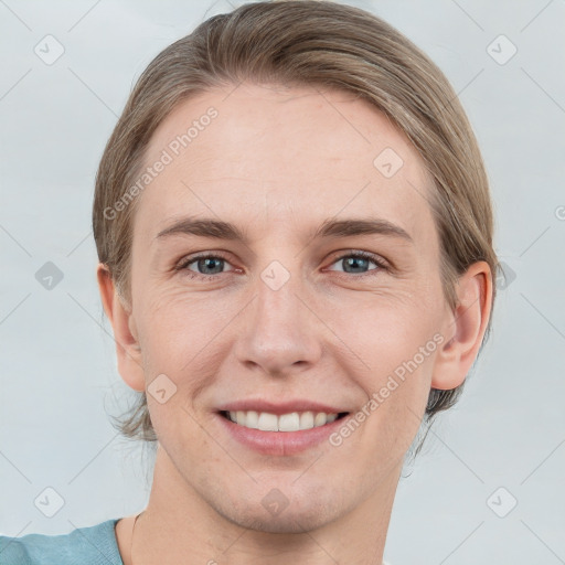 Joyful white young-adult female with short  brown hair and grey eyes