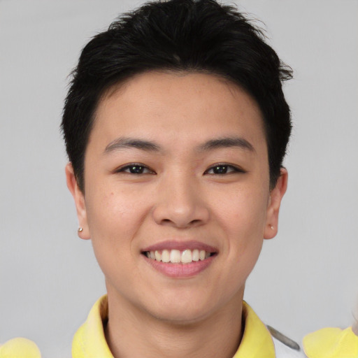 Joyful asian young-adult female with short  brown hair and brown eyes
