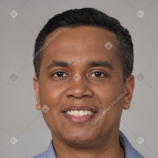 Joyful latino adult male with short  black hair and brown eyes