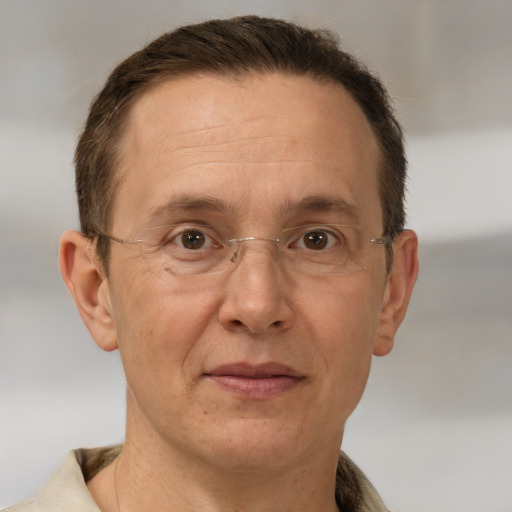 Joyful white adult male with short  brown hair and brown eyes