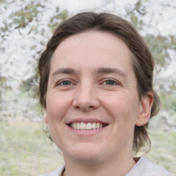 Joyful white adult female with medium  brown hair and grey eyes