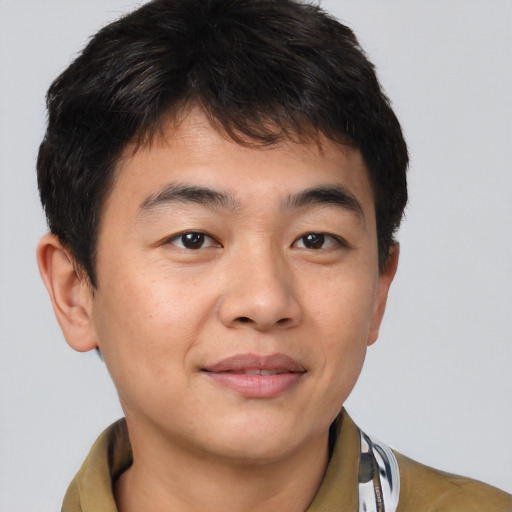 Joyful latino young-adult male with short  brown hair and brown eyes