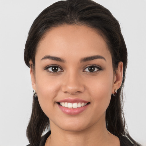 Joyful white young-adult female with long  brown hair and brown eyes