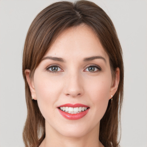 Joyful white young-adult female with long  brown hair and grey eyes