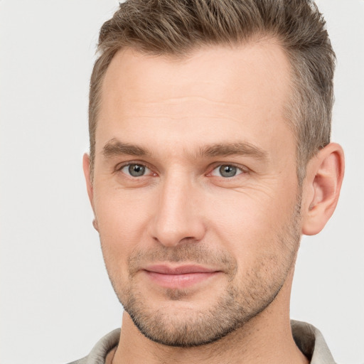 Joyful white adult male with short  brown hair and brown eyes