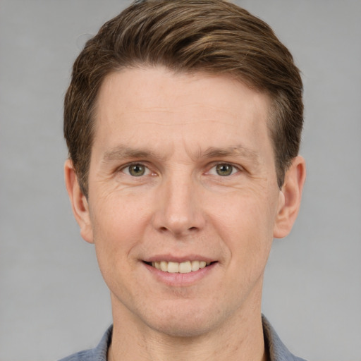 Joyful white adult male with short  brown hair and grey eyes