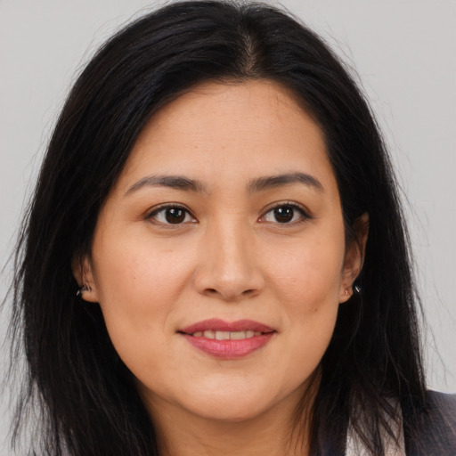 Joyful asian young-adult female with long  brown hair and brown eyes