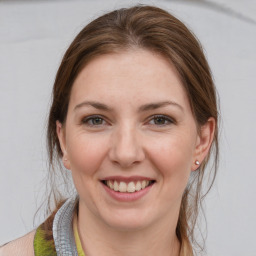 Joyful white young-adult female with medium  brown hair and grey eyes