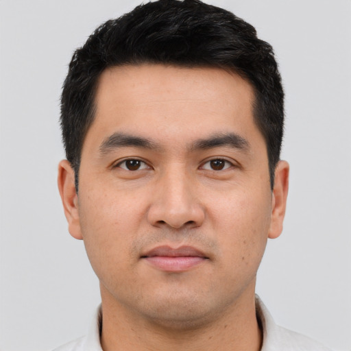 Joyful asian young-adult male with short  black hair and brown eyes
