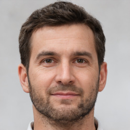 Joyful white young-adult male with short  brown hair and brown eyes