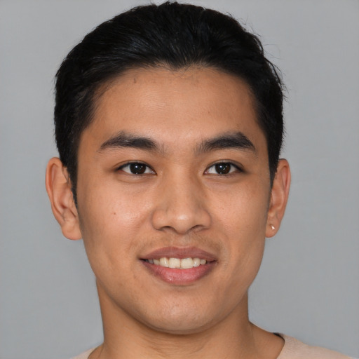 Joyful asian young-adult male with short  black hair and brown eyes
