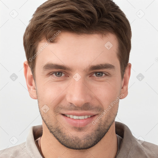 Joyful white young-adult male with short  brown hair and grey eyes