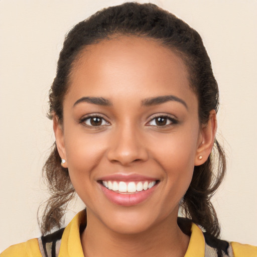 Joyful latino young-adult female with long  brown hair and brown eyes