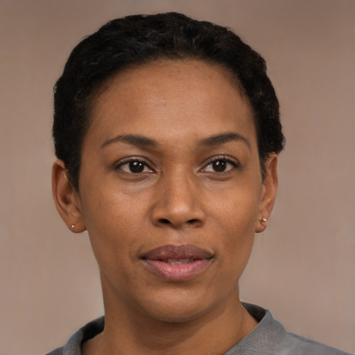 Joyful latino young-adult female with short  black hair and brown eyes
