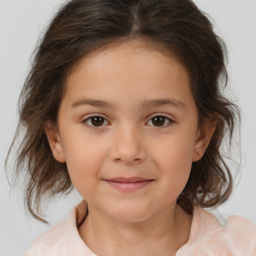 Joyful white child female with medium  brown hair and brown eyes