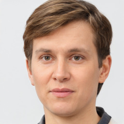 Joyful white young-adult male with short  brown hair and grey eyes