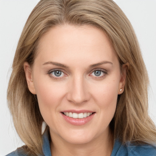 Joyful white young-adult female with medium  brown hair and blue eyes