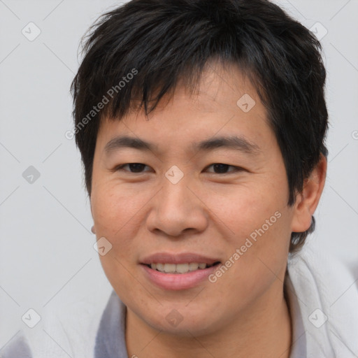 Joyful asian young-adult male with short  brown hair and brown eyes