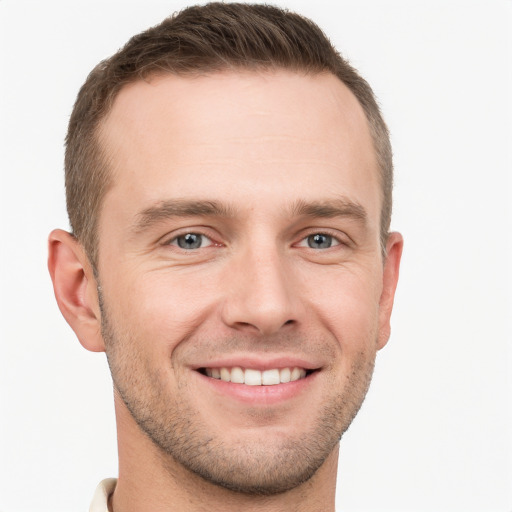 Joyful white young-adult male with short  brown hair and grey eyes