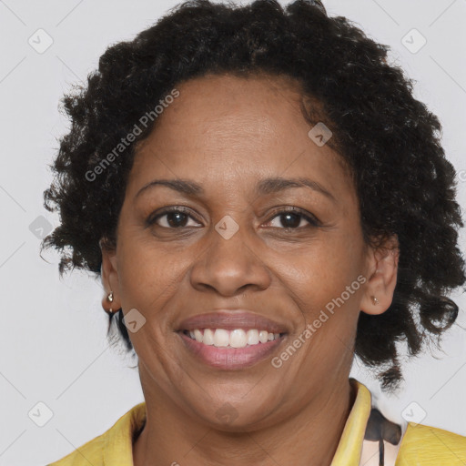 Joyful black adult female with short  brown hair and brown eyes