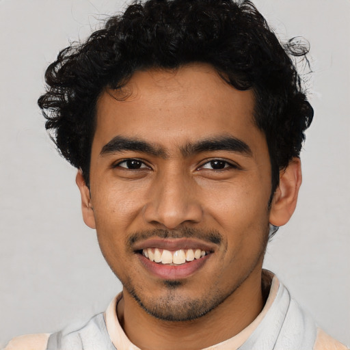 Joyful latino young-adult male with short  black hair and brown eyes