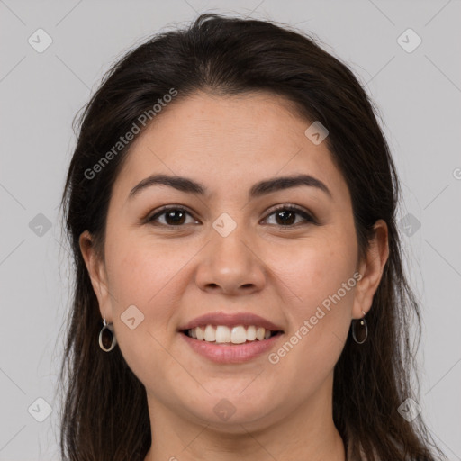 Joyful white young-adult female with long  brown hair and brown eyes