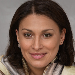 Joyful white adult female with long  brown hair and brown eyes