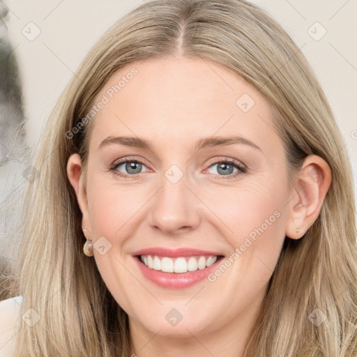 Joyful white young-adult female with long  brown hair and blue eyes