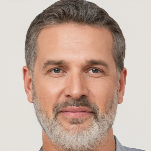 Joyful white middle-aged male with short  brown hair and brown eyes