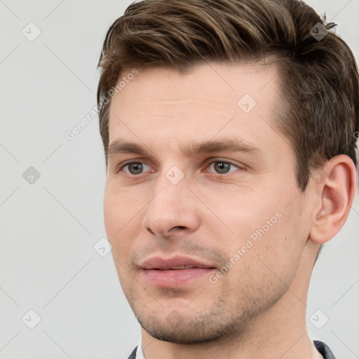 Joyful white young-adult male with short  brown hair and grey eyes