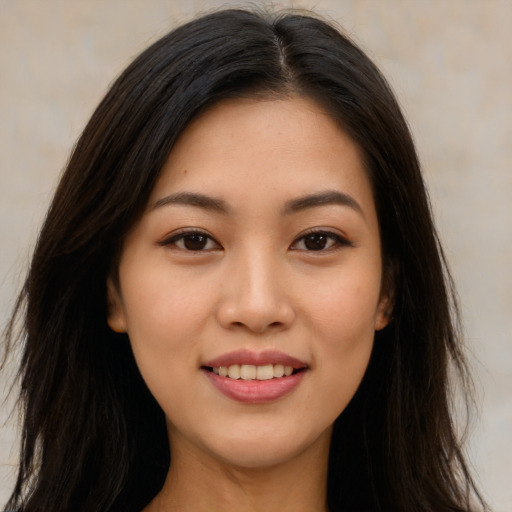 Joyful asian young-adult female with long  brown hair and brown eyes