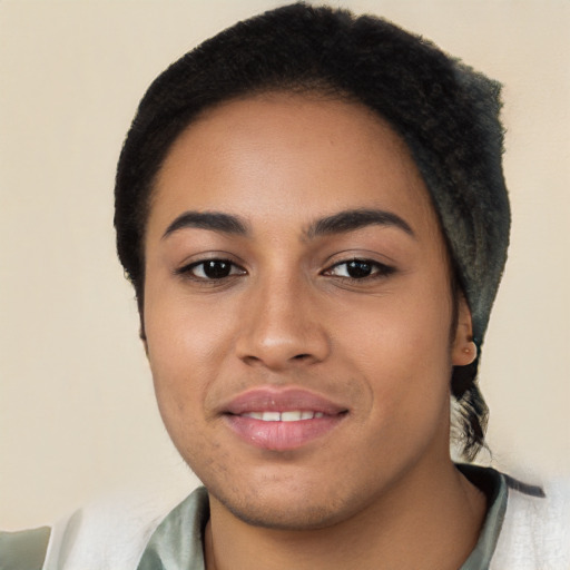 Joyful latino young-adult female with short  black hair and brown eyes