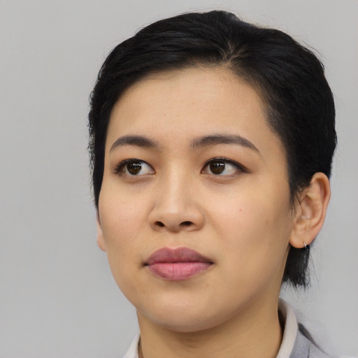 Joyful asian young-adult female with medium  black hair and brown eyes