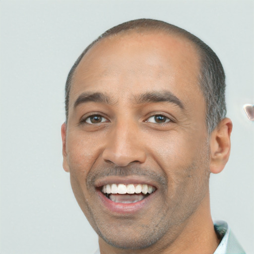 Joyful white adult male with short  black hair and brown eyes