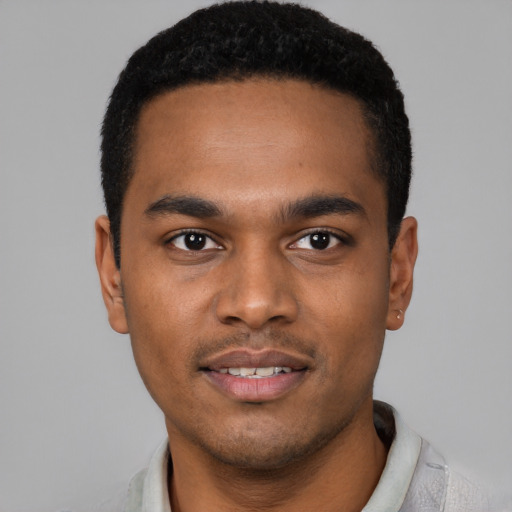 Joyful black young-adult male with short  black hair and brown eyes
