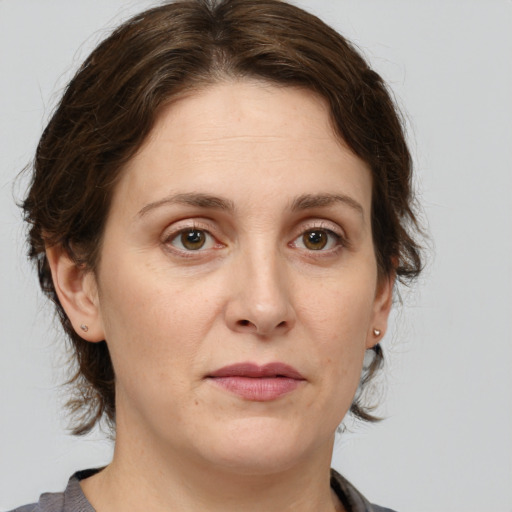 Joyful white adult female with medium  brown hair and grey eyes