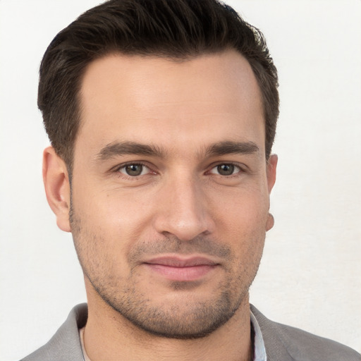 Joyful white young-adult male with short  brown hair and brown eyes