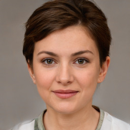 Joyful white young-adult female with short  brown hair and grey eyes