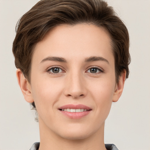 Joyful white young-adult female with short  brown hair and grey eyes