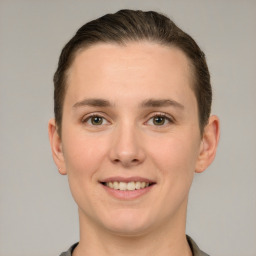 Joyful white young-adult female with short  brown hair and grey eyes