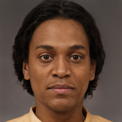 Joyful black adult female with short  brown hair and brown eyes
