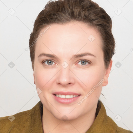 Joyful white young-adult female with short  brown hair and grey eyes