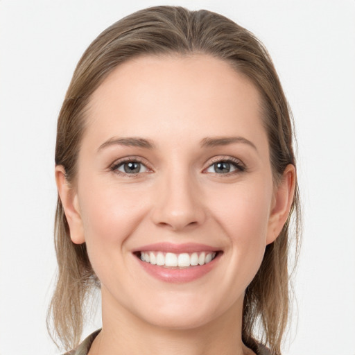 Joyful white young-adult female with long  brown hair and grey eyes