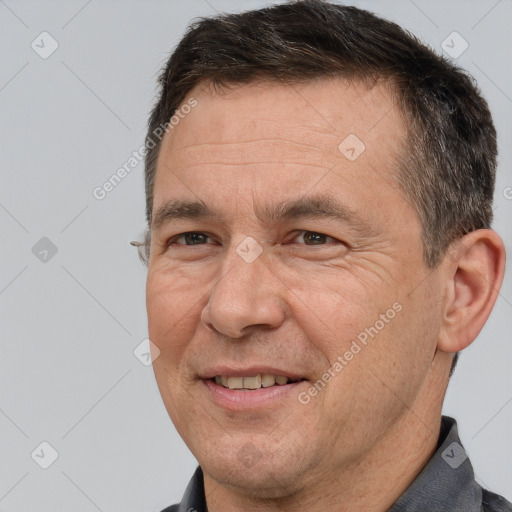 Joyful white adult male with short  brown hair and brown eyes