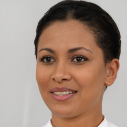 Joyful latino young-adult female with short  brown hair and brown eyes