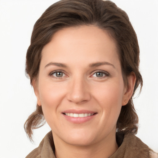 Joyful white young-adult female with medium  brown hair and grey eyes