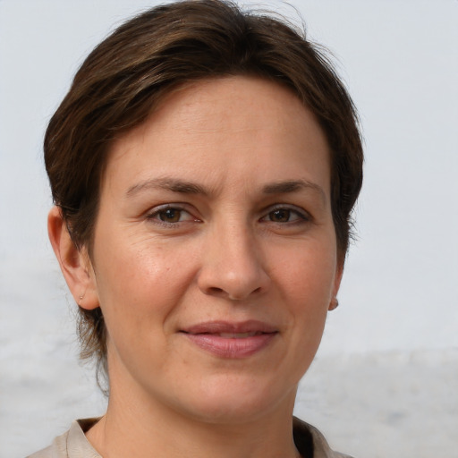 Joyful white adult female with short  brown hair and grey eyes